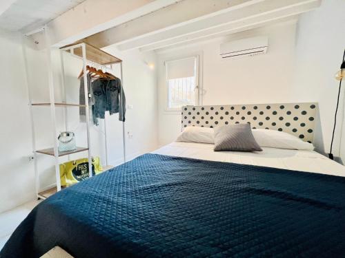 a bedroom with a large bed with a blue blanket at CIVICO475 House Chioggia in Chioggia