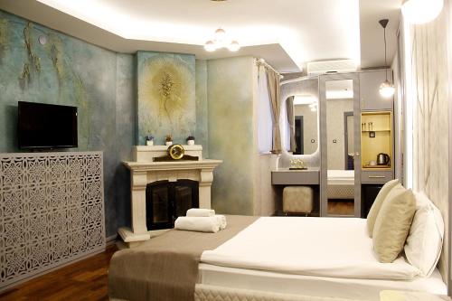 a bedroom with a bed and a fireplace and a bathroom at Cadde 7 Otel in Ankara