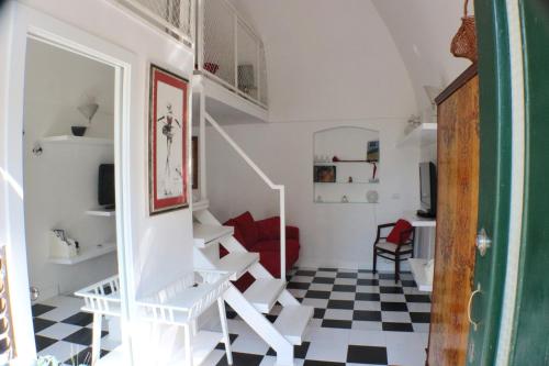 a white staircase in a room with a checkered floor at Dolce Loft in Bari