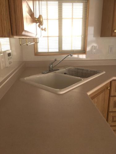 a white sink in a kitchen with a window at TOYA LAKEHILL CABIN - The lake view cabin at Lake Toya in Lake Toya