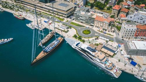 two boats docked in a marina next to a city at Paparazzi Apartment in Split