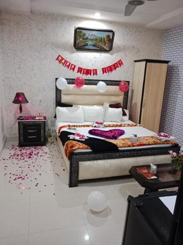 a bedroom with a bed with a happy new year banner at Hotel Tulip Inn in Lahore