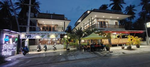 a group of motorcycles parked in front of a building at Le Grand Bleu Hotel in Wok Tum