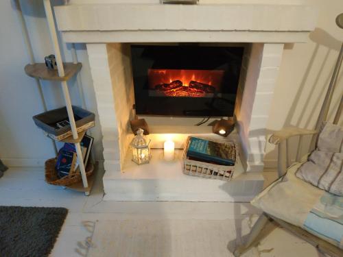 a fireplace in a living room with a fire place at Chez Christy Chemin des Dinots in Saint-Bonnet-de-Four