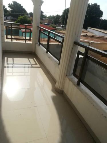 an empty balcony with two windows in a building at HEBERTOGO Casablanca in Lomé