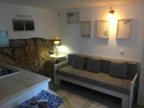 a living room with a couch and a table at Traditional House Ekaterini Alonissos in Alonnisos