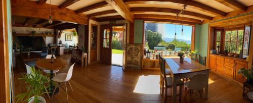 a living room with a table and chairs and a kitchen at Selva India Suites in San Carlos de Bariloche