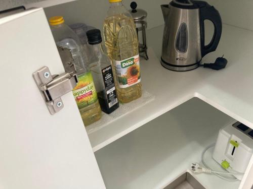 a kitchen counter with bottles of food and a blender at Cactus Home Penthouse in La Garita
