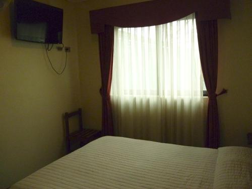 Säng eller sängar i ett rum på Hotel de la Avenida