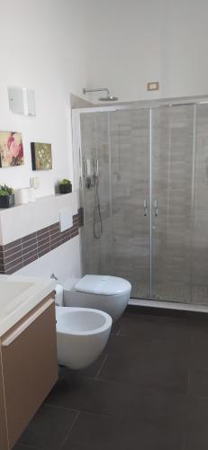 a bathroom with a shower and a toilet and a sink at Agriturismo La Pietra 1 e La Pietra 2 in La Spezia