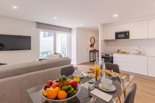 a living room with a table with a bowl of fruit at PDL Apartment in Ponta Delgada