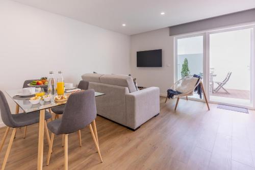 a living room with a table and a couch at PDL Apartment in Ponta Delgada