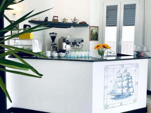 a kitchen with a counter with a drawing of a ship at Hotel Doria in Chiavari