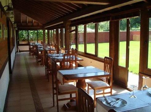 a row of tables and chairs in a restaurant at Posada Restaurante Prada a Tope in Treceño