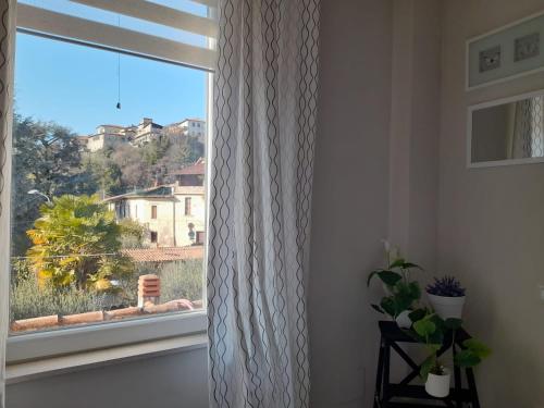 a window with a white curtain in a room at LaRiva 11 L'angolo segreto di Sarnico Lake Iseo in Sarnico