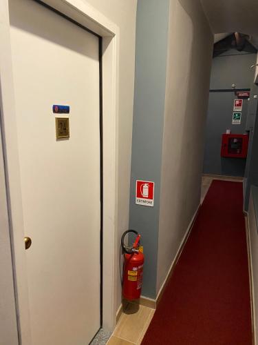 a fire hydrant next to a door in a fire station at Artua'&Solferino in Turin