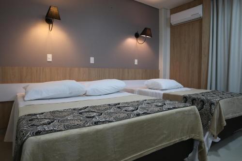 Ліжко або ліжка в номері Hotel Plaza Cascavel