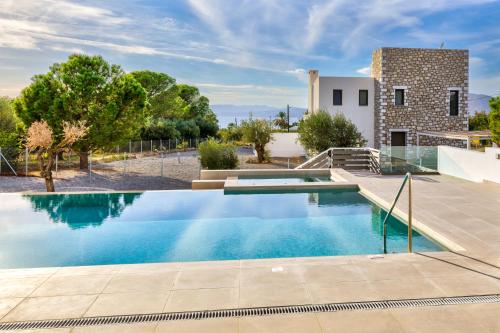 a villa with a swimming pool and a house at Villa Lara AmberBlue Pefkos in Pefki Rhodes
