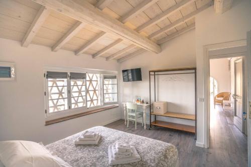 a bedroom with a bed and a window and a desk at La Magnolia in Greve in Chianti