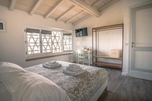 a bedroom with a bed with towels on it at La Magnolia in Greve in Chianti