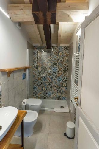 a bathroom with a toilet and a sink and a shower at La Magnolia in Greve in Chianti
