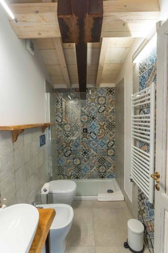 a bathroom with a toilet and a sink and a shower at La Magnolia in Greve in Chianti