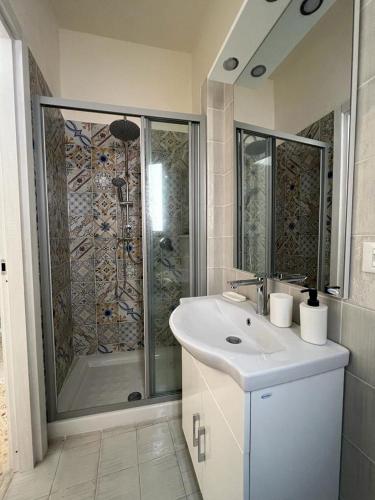 a bathroom with a shower and a sink and a shower at Rua House in Corleone