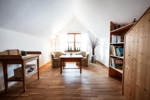 a living room with a table and a book shelf at Winzerzimmer Pronegg vlg. Kristeindl in Leutschach