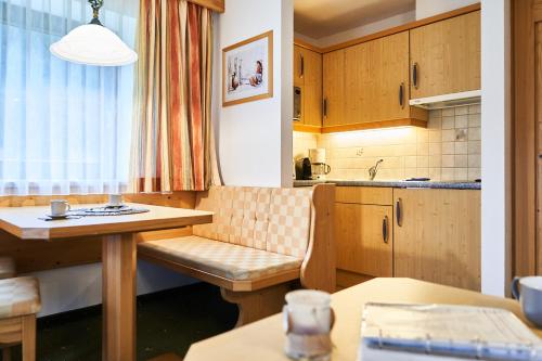 a small kitchen with a table and a table and a table at Haus Sonnenweg in Leutasch