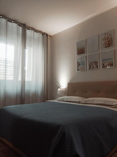 a bedroom with a large bed and a window at GF Holiday Suite 2 in Varazze