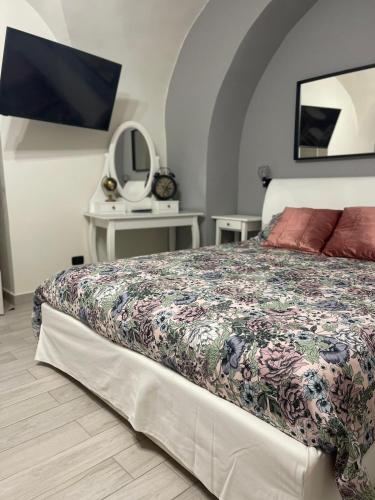 a bedroom with a bed and a tv on a wall at AC HOME in Catania