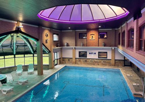 a large swimming pool in the middle of a room at Springfield Country Hotel, Leisure Club & Spa in Wareham