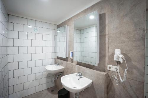 a bathroom with a sink and a mirror at Bobopod Tanah Abang, Jakarta in Jakarta