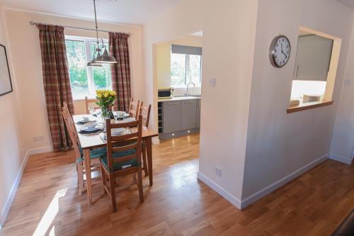 a kitchen and dining room with a table and chairs at Birchbrae Highland Lodges in Onich