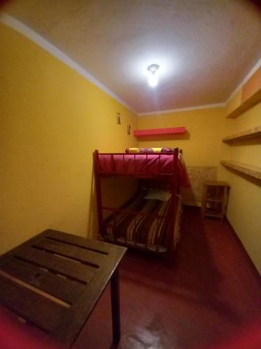 a room with two bunk beds in a room at Monkeywasi Climbing Hostel in Huaraz