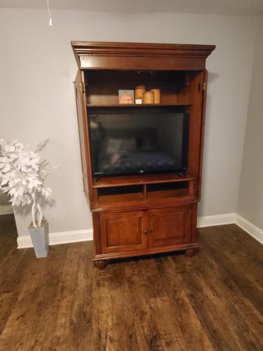 a wooden entertainment center with a flat screen tv at Spacious Atlanta 2Bedroom/ 2Full Baths Renovated in Atlanta