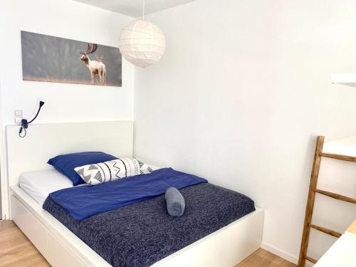 a small bedroom with a bed with blue sheets at Ferienwohnung Schwarzwaldstraße in Pforzheim