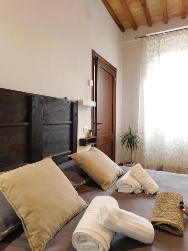 a bedroom with a bed with two towels on it at Otello Guest House in Montalcino