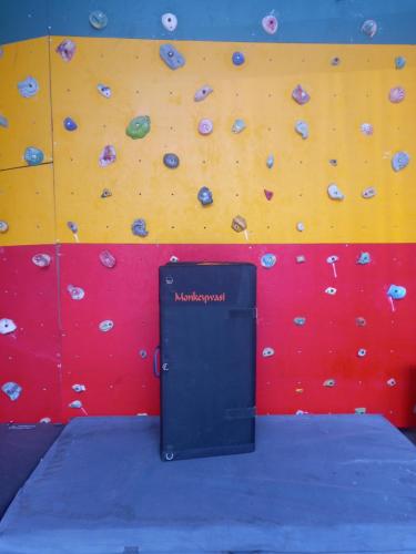a rock wall with a black box in front of it at Monkeywasi Climbing Hostel in Huaraz