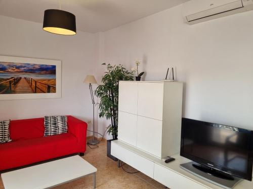 A television and/or entertainment centre at Hello Oliva Beach Ana