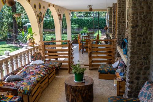 a room with couches and chairs and a table at Kiwavi Home in Moshi
