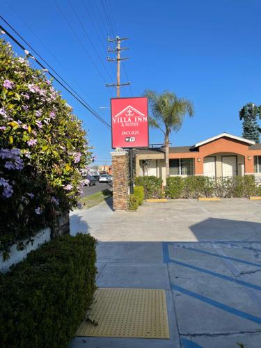 a sign for a hotel on a street at Villa Inn & Suites - LAX, SoFi Stadium & Intuit Dome in Inglewood