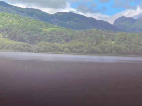 a view of a lake with mountains in the background at Troutbeck Hot Tub Lodge 4 in Windermere