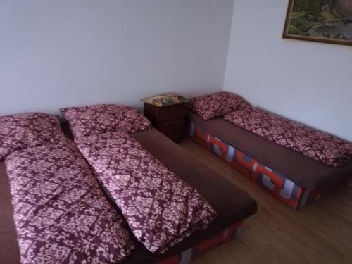 two beds in a room with pink blankets at Penzión Larix Blatnica in Blatnica