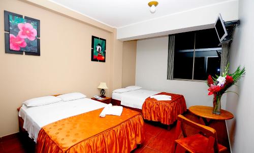 Ένα ή περισσότερα κρεβάτια σε δωμάτιο στο Hotel Puerto Amazonico