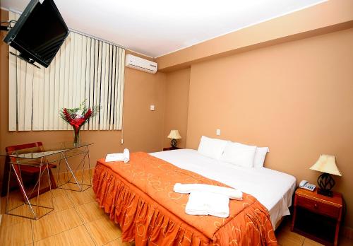 Ένα ή περισσότερα κρεβάτια σε δωμάτιο στο Hotel Puerto Amazonico