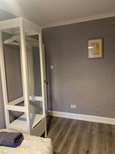 a bedroom with a white bunk bed and a mirror at Nevis Rooms - Self check in with free onsite Parking in Inverlochy
