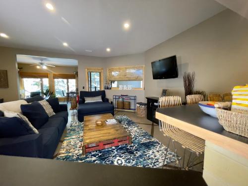 a living room with a couch and a table at Blanchard Mountain BnB in Canmore