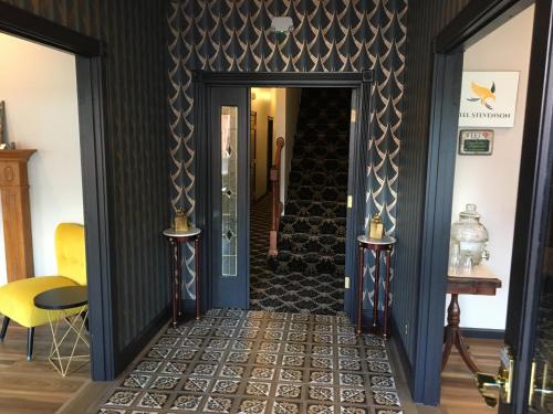 a hallway with black walls and a blue door at Hotel Stevenson in Stevenson