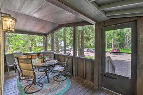 a screened in porch with a table and chairs at 2 Bedroom Cabin Inside Glacier National Park in West Glacier